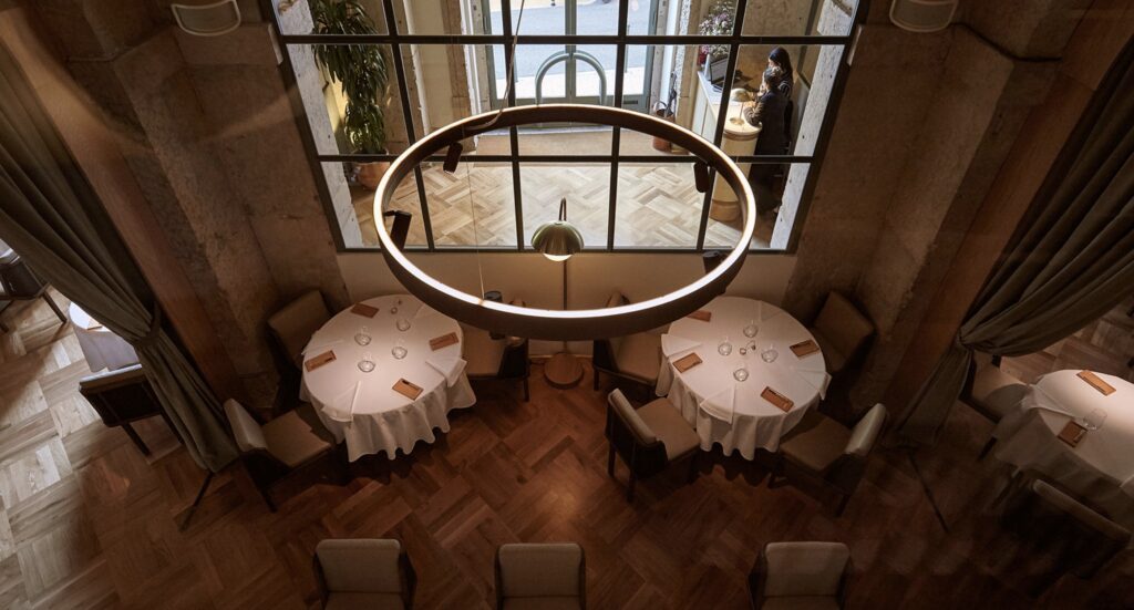 The vaulted ceiling of Lisbon's Belcanto look down on white-napkined tables and stylish industrial features.